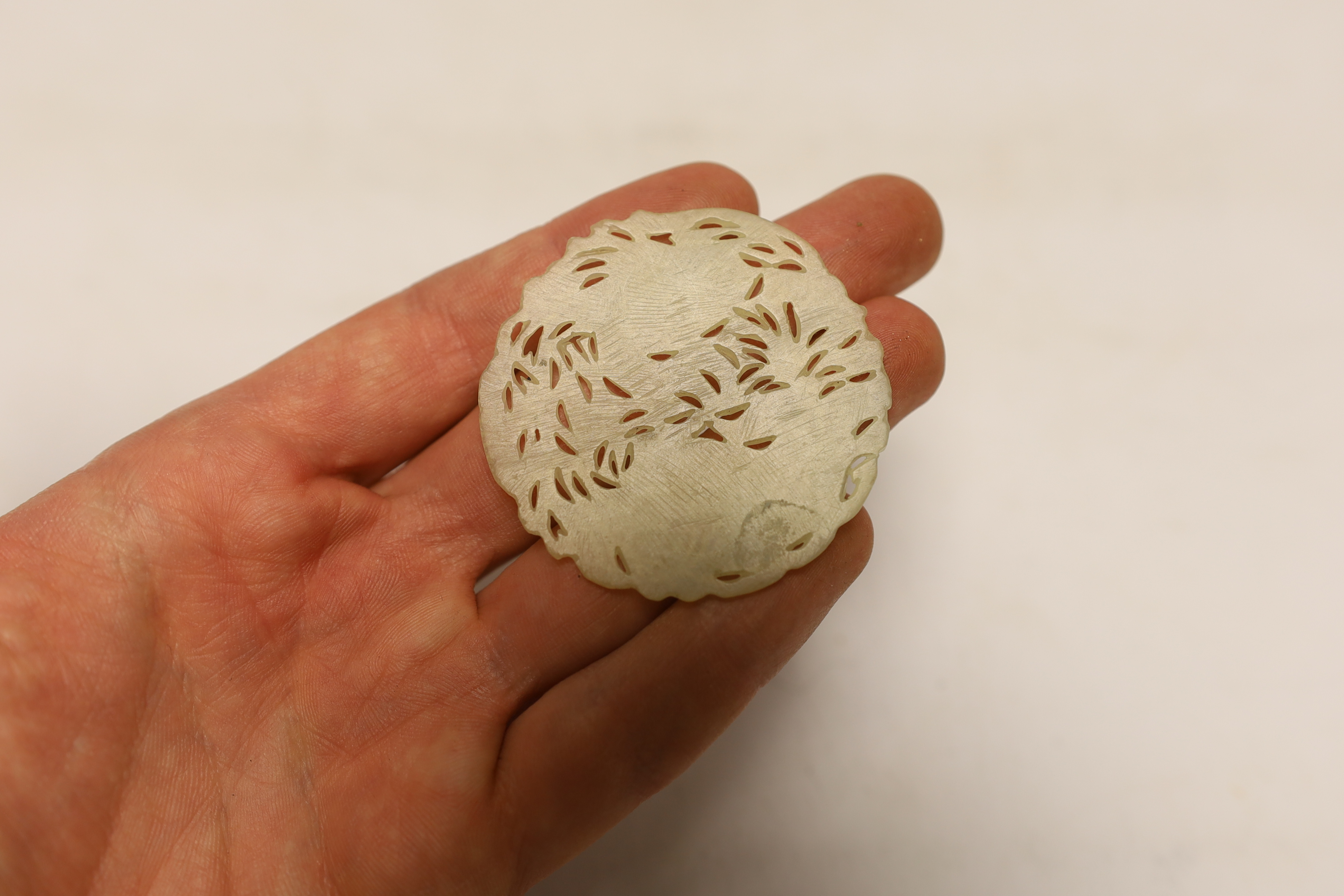 Two Chinese lion dog seals, a carved jade disc, a hard stone disc with partial wax seal and carved figure